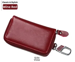 Side view of wine red lychee grain leather car key case with silver zipper and swivel hook
