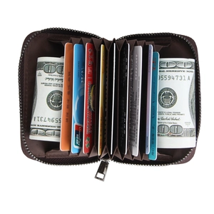 Detail view of leather accordion card holder with 9 slots and secure metal zipper