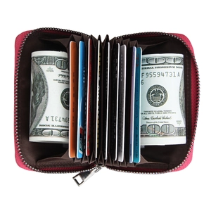 Macro view of rose red leather accordion card holder with functional zipper and multiple slots