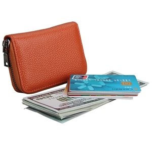 Detailed view of orange pebbled leather wallet with L-zip and cards for capacity check