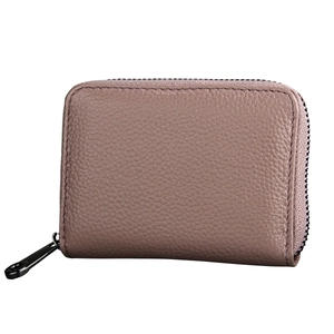 Macro detail of lychee grain leather texture and metallic zipper on pink RFID card wallet