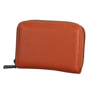 Close-up of orange litchi leather texture and dark metallic zipper on small card holder