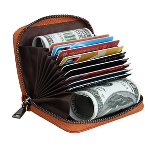 Macro view of orange lychee leather card holder with multi-slot accordion interior and zipper
