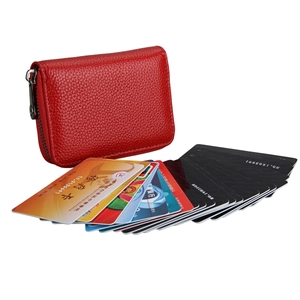 Detail view of red litchi grain leather RFID card holder with multiple slots and zip closure
