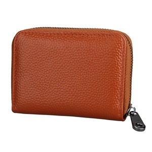 Detail view of the orange lychee grain leather wallet with a secure U-shaped zipper closure