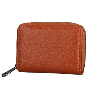 Detail of caramel brown lychee leather texture and metal zipper on RFID card holder wallet