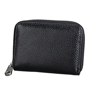 Close-up of black litchi grain leather card holder with secure metal zipper closure