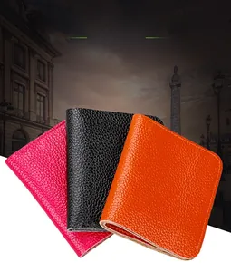 Litchi pattern genuine leather card holders in magenta, black and orange stacked together