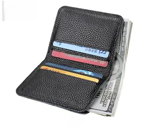 Detail of slim black lychee-grain leather card holder showing slots and cash compartment