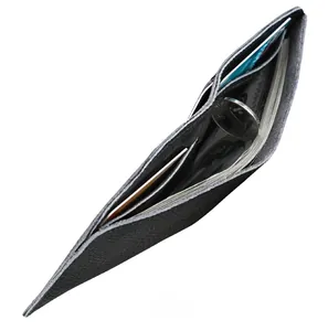 Macro view of black grain leather card holder showing internal slots and folded cash space