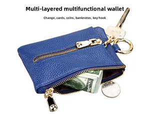 Blue pebbled leather multi-functional key pouch showing coins and bills storage