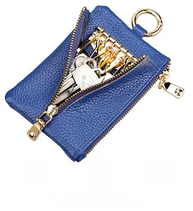 Blue lychee grain leather key pouch detail with six interior metal hooks and gold zipper