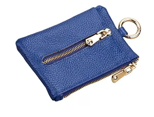 Detailed side view of deep blue pebble grain leather coin purse with gold zippers