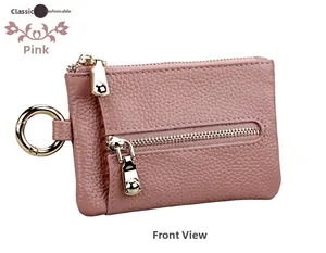 Macro detail of dusty pink lychee grain leather wallet with golden metal zipper and ring