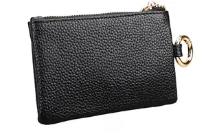 Macro detail of the black lychee pattern leather back with gold ring attachment
