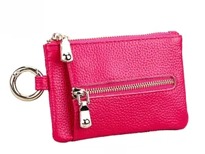 Detail of rose red lychee texture leather coin purse with double gold zippers and metal ring