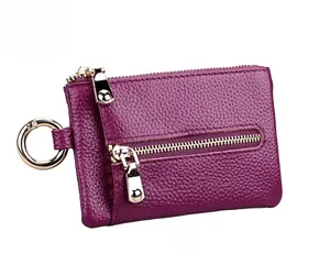 Detail view of purple lychee grain leather keychain wallet with dual silver zippers