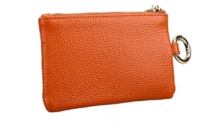 Detail view of the back of the orange pebble leather coin purse with golden zipper