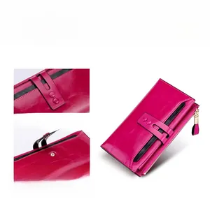 Detail of rose red leather long wallet featuring secure dual snap fasteners and zipper pocket