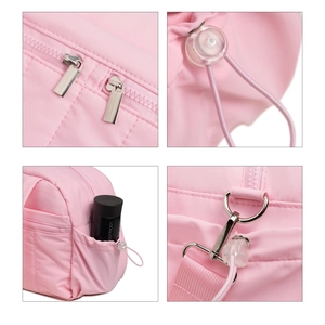 Pink waterproof travel bag with laptop compartment, dual zippers and side elastic pockets