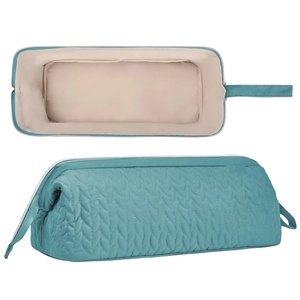 Quilted hair dryer storage bag in teal with zipper closure and side handle for travel