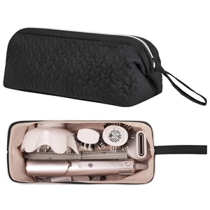Detail of black quilted hair tool storage bag with pink lining and organized compartments