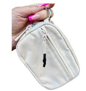 Detail of beige nylon coin purse featuring metallic ring clasp and checkered zipper trim