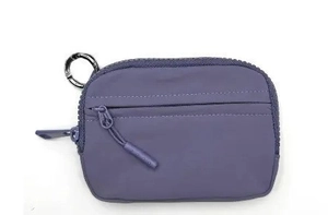Detail view of purple waterproof nylon coin purse with metal ring and zip pocket