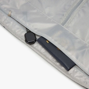 Light gray multi-compartment travel bag with high-density polyester and metal zippers
