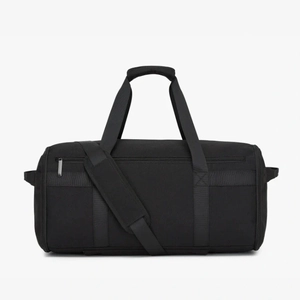 Close-up of durable black travel bag showing reinforced handles and metal zipper detail
