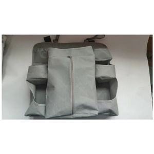 Close-up of grey crib hanging organizer featuring multiple storage pockets and zipper
