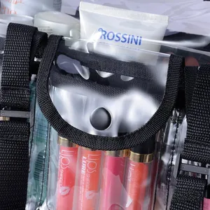 Detail of transparent PVC travel bag showing black strap and makeup storage compartment