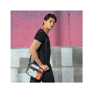 Detailed view of clear PVC crossbody bag with black zipper worn by a male model