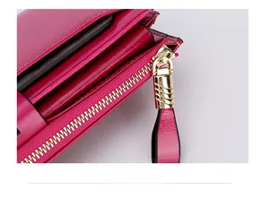 Detailed close-up of rose red leather wallet with premium golden metal zipper and stitching