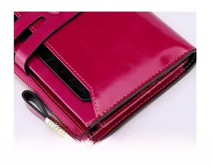 Close-up of pink RFID leather wallet showing fine stitching and gold zipper detail