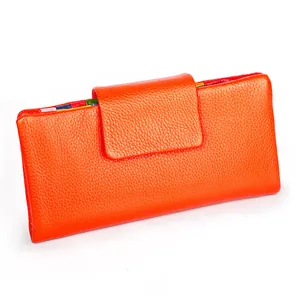 Detail view of orange pebbled leather long wallet with multi-color interior card slots