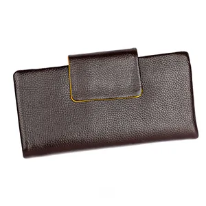 Macro detail of dark brown litchi grain leather wallet with vibrant yellow oil edges
