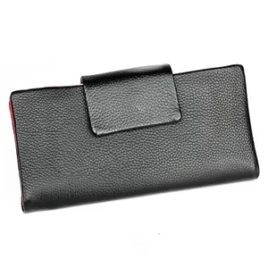 Close-up of black litchi grain leather long wallet with red interior contrast