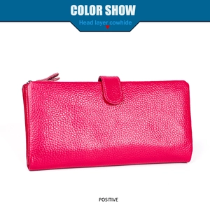Detail of rose red pebble grain head layer cowhide wallet with secure zipper and strap buckle
