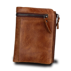 Detail of genuine brown leather wallet showing natural texture and double zipper design