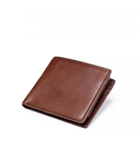 Detailed view of the fine natural leather grain and brown stitching on a bifold wallet