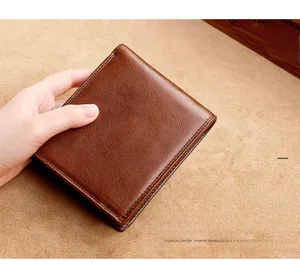 Close-up of soft brown genuine leather wallet texture with neat stitching detail