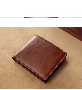 Close-up of coffee brown leather wallet with natural lychee texture and fine stitching
