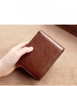 Close-up of a handmade dark brown genuine leather wallet with precise stitching details