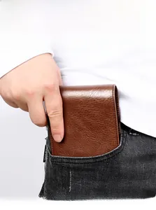 Compact brown leather bifold wallet easily fits into a denim jeans pocket for daily use