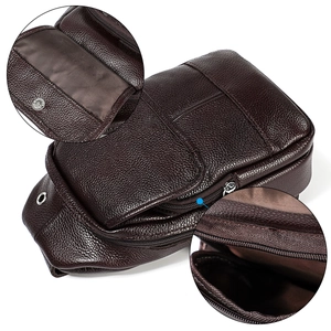 Detail of genuine leather sling bag showing magnetic snap and durable zipper stitching