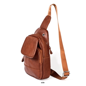 Side view of brown leather chest bag with zipper layers and headphone jack detail