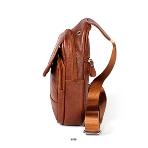 Side view of dark brown pebbled leather sling bag with multiple zippers and wide strap