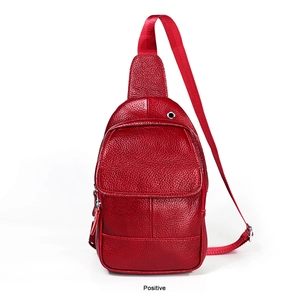Front view of red lychee grain leather sling bag with adjustable strap and metal earphone hole