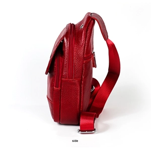 Side view of red pebble leather chest bag with layered zippers and metallic buckle